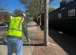 A photo of a volunteer picking up litter 